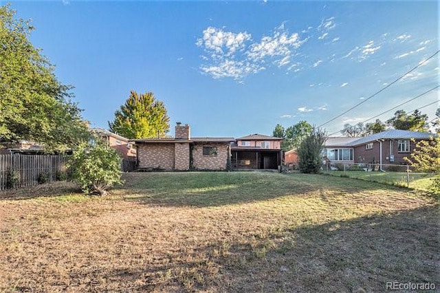 rear view of house with a yard