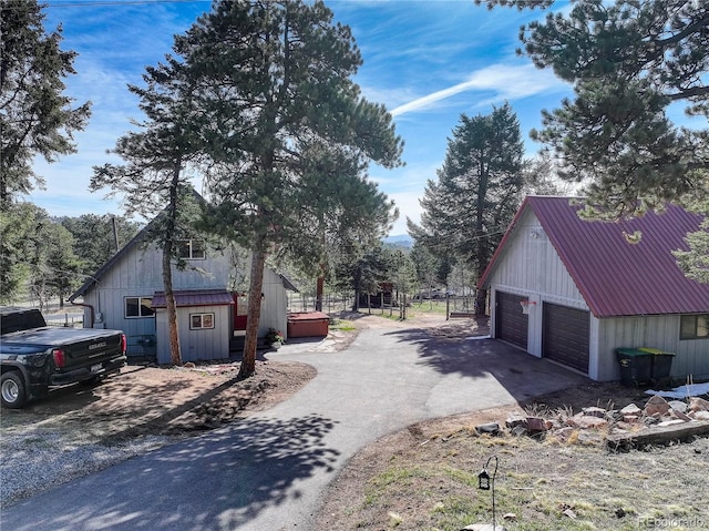 952 Burland Dr, Bailey, CO 80421 - view of side of property with an outbuilding, a detached garage, and metal roof