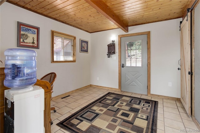 952 Burland Dr, Bailey, CO 80421 - entryway featuring plenty of natural light, light tile patterned floors, wooden ceiling with exposed beams, and a barn door