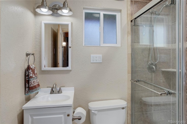 952 Burland Dr, Bailey, CO 80421 - bathroom with toilet, vanity, a shower stall, and a textured wall