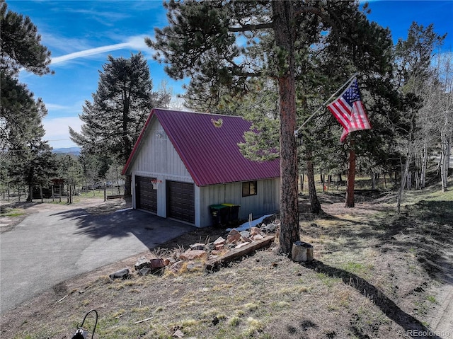952 Burland Dr, Bailey, CO 80421 - view of side of home with a garage, an outdoor structure, and metal roof