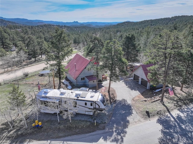 952 Burland Dr, Bailey, CO 80421 - aerial view of property and surrounding area featuring a heavily wooded area and a mountain backdrop