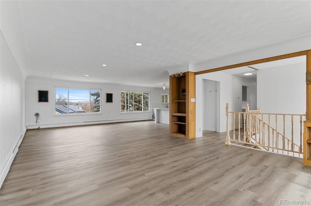 4731 W 66th Ave, Arvada, CO 80003 - unfurnished living room featuring light wood-type flooring, baseboards, recessed lighting, and baseboard heating