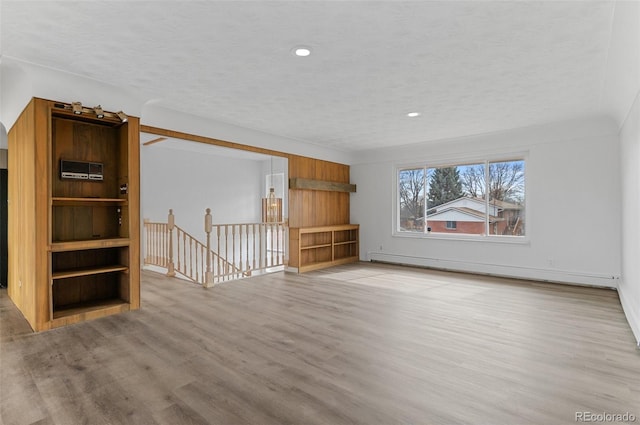 4731 W 66th Ave, Arvada, CO 80003 - unfurnished living room featuring baseboard heating, wood finished floors, recessed lighting, baseboards, and a textured ceiling