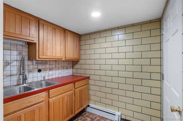 4731 W 66th Ave, Arvada, CO 80003 - kitchen with a sink, decorative backsplash, brown cabinetry, recessed lighting, and baseboard heating