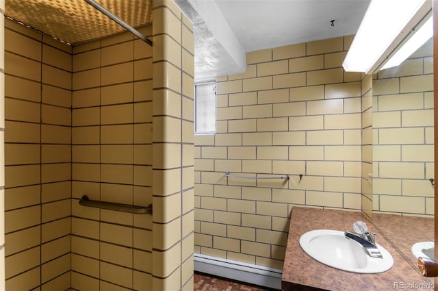 4731 W 66th Ave, Arvada, CO 80003 - bathroom featuring tiled shower, tile walls, vanity, and a baseboard radiator
