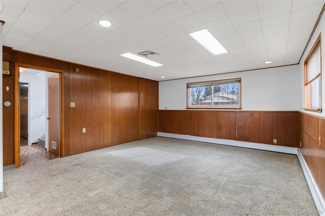 4731 W 66th Ave, Arvada, CO 80003 - empty room featuring wooden walls, carpet floors, baseboard heating, a baseboard radiator, and a wainscoted wall