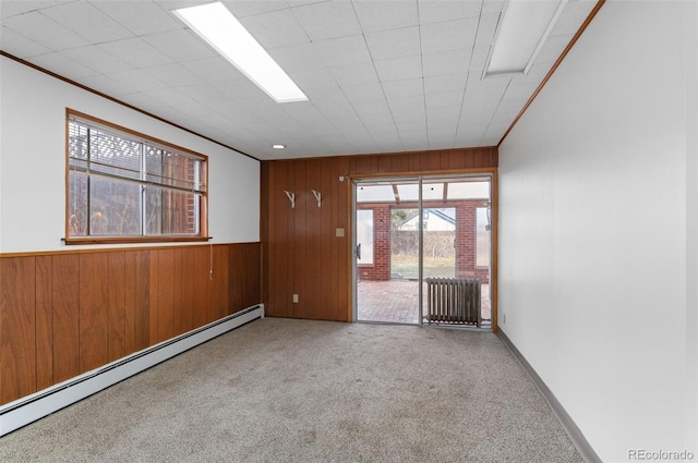 4731 W 66th Ave, Arvada, CO 80003 - spare room featuring baseboard heating, wood walls, radiator, and carpet floors