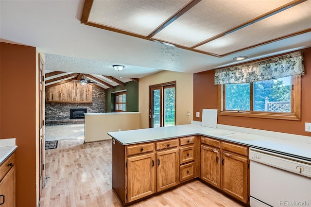 20596 E Shefield Ct, Parker, CO 80138 - kitchen featuring dishwasher, a brick fireplace, a peninsula, light wood-type flooring, and brown cabinetry