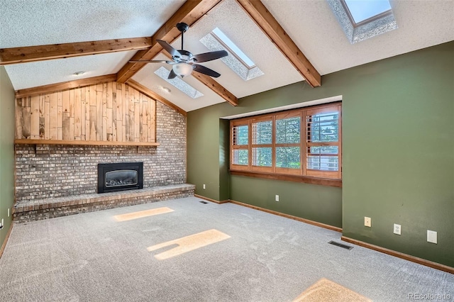 20596 E Shefield Ct, Parker, CO 80138 - unfurnished living room featuring a skylight, a fireplace, carpet flooring, ceiling fan, and a textured ceiling