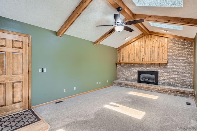 20596 E Shefield Ct, Parker, CO 80138 - unfurnished living room with a skylight, a ceiling fan, a fireplace, a textured ceiling, and carpet floors