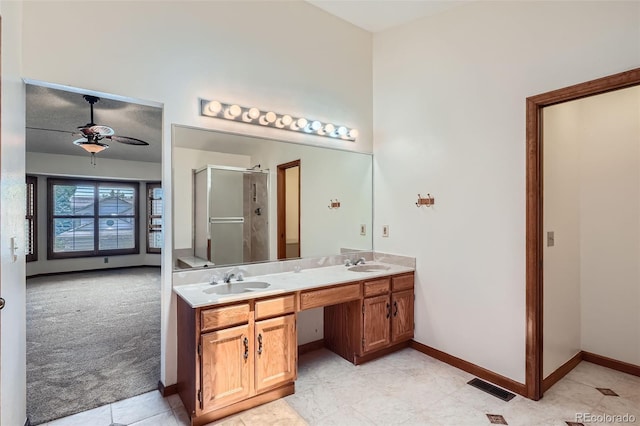 20596 E Shefield Ct, Parker, CO 80138 - full bath with a stall shower, double vanity, a ceiling fan, and tile patterned floors
