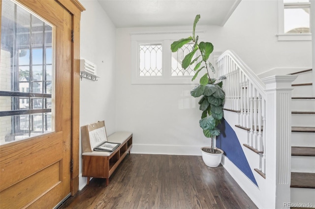 doorway with stairway, dark wood-style floors, and baseboards