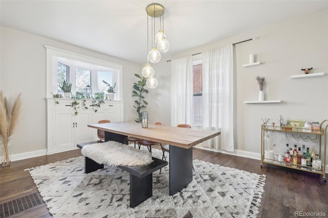 dining space with wood finished floors and baseboards