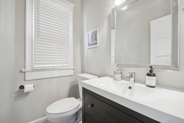 bathroom featuring toilet and vanity