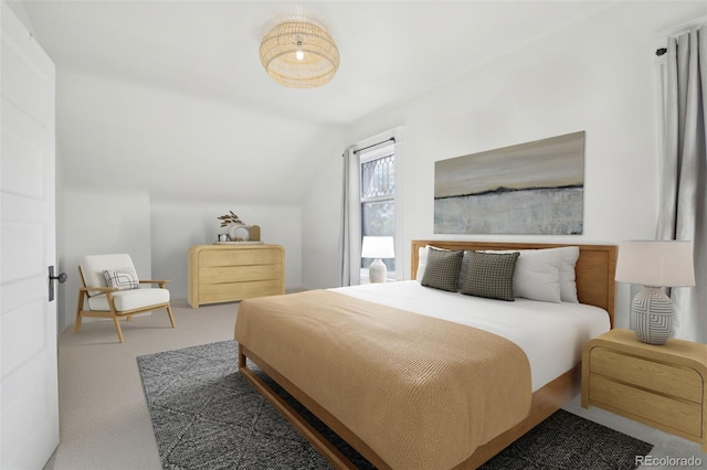 carpeted bedroom featuring lofted ceiling