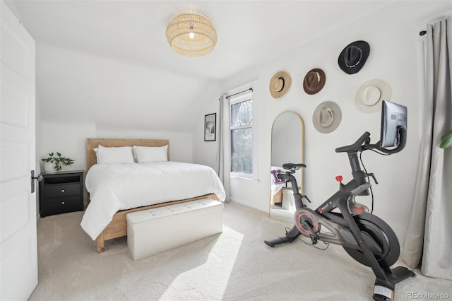 bedroom with lofted ceiling and light carpet