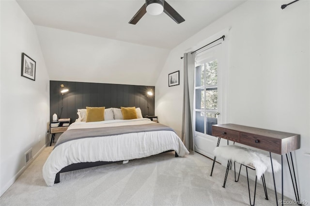 carpeted bedroom featuring vaulted ceiling and a ceiling fan