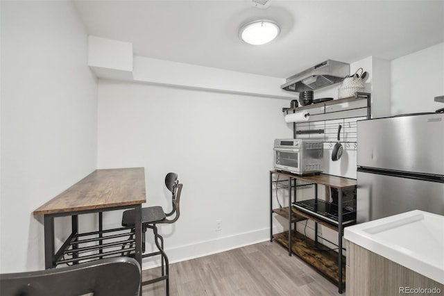 office space featuring light wood-type flooring and baseboards