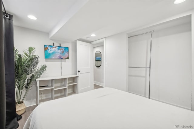 bedroom with recessed lighting, baseboards, and wood finished floors