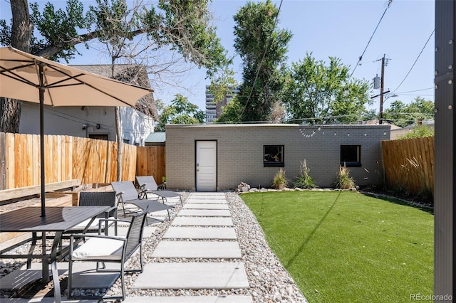 back of property with brick siding, a patio, and outdoor dining space