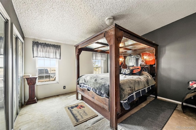 carpeted bedroom with a textured ceiling and multiple windows