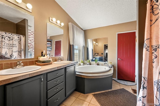 bathroom with tile patterned floors, lofted ceiling, a bathing tub, vanity, and a textured ceiling