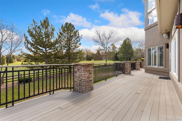 wooden deck featuring a yard