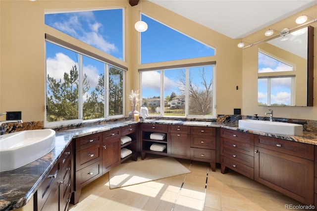 bathroom featuring vanity and high vaulted ceiling