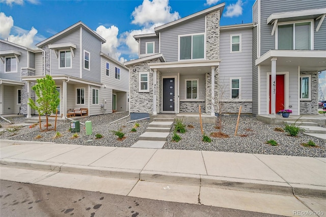 4612 S Wenatchee St Unit A, Aurora, CO 80015 - view of front of property featuring stone siding and a porch