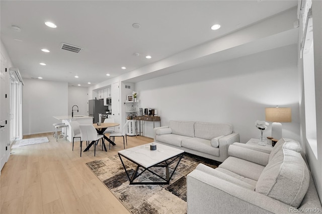 4612 S Wenatchee St Unit A, Aurora, CO 80015 - living room featuring recessed lighting and light wood-style flooring