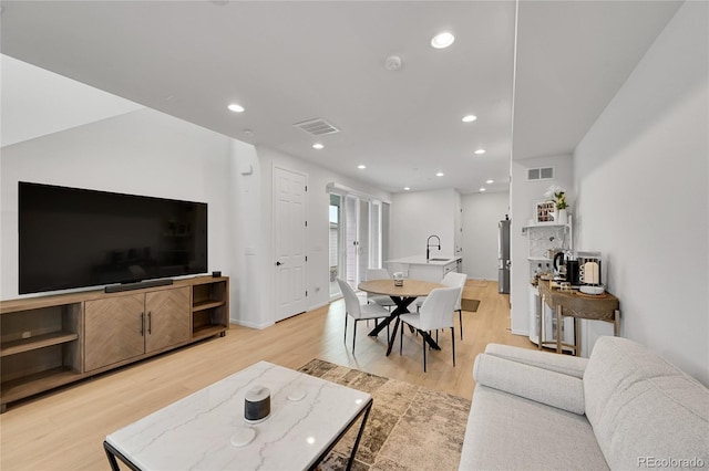 4612 S Wenatchee St Unit A, Aurora, CO 80015 - living area featuring light wood-style flooring and recessed lighting