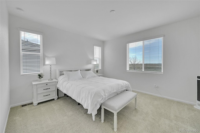 4612 S Wenatchee St Unit A, Aurora, CO 80015 - bedroom featuring multiple windows and light colored carpet