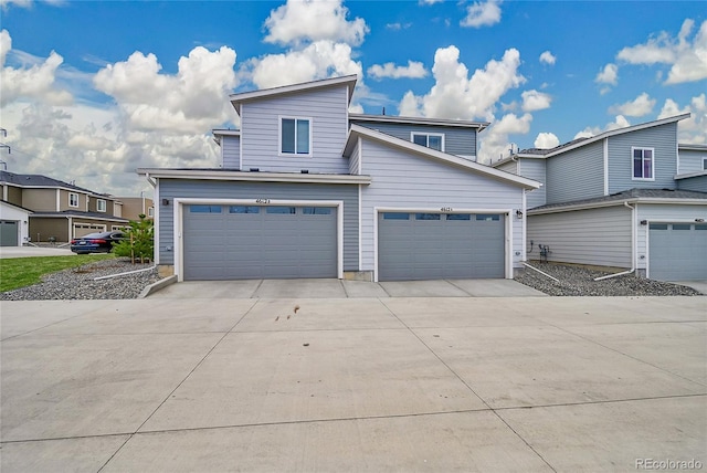 4612 S Wenatchee St Unit A, Aurora, CO 80015 - view of front facade featuring driveway and a garage