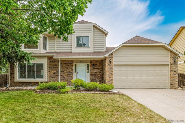 6005 S Vivian St, Littleton, CO 80127 - view of front of house featuring concrete driveway, brick siding, an attached garage, a front lawn, and a shingled roof