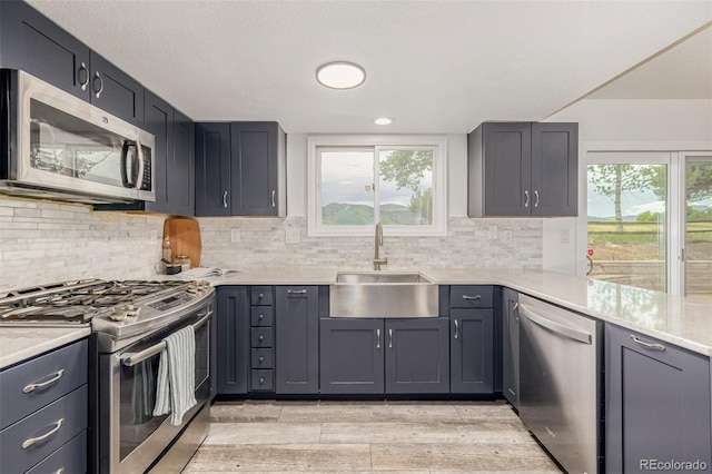 6005 S Vivian St, Littleton, CO 80127 - kitchen with stainless steel appliances, light wood-type flooring, light countertops, tasteful backsplash, and recessed lighting