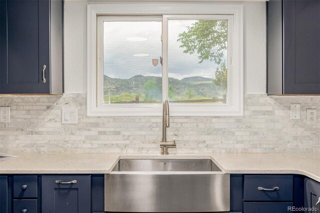 6005 S Vivian St, Littleton, CO 80127 - kitchen with blue cabinetry and backsplash