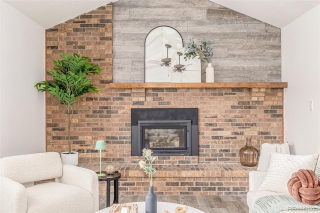 6005 S Vivian St, Littleton, CO 80127 - living room with lofted ceiling, wood finished floors, wood walls, a ceiling fan, and a brick fireplace