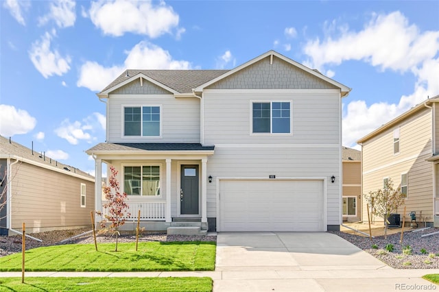 view of front of home featuring central AC, a garage, and a front yard