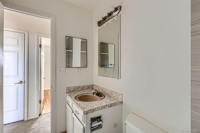 bathroom featuring toilet and vanity