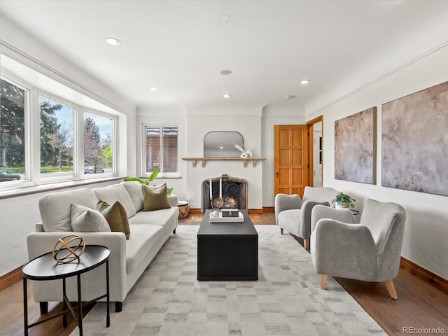 2535 Leyden St, Denver, CO 80207 - living room with baseboards, light wood finished floors, recessed lighting, and a warm lit fireplace
