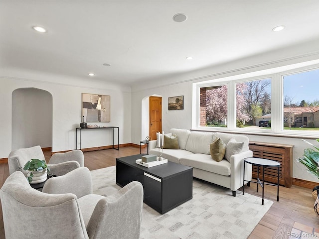 2535 Leyden St, Denver, CO 80207 - living room featuring arched walkways, light wood-style floors, baseboards, and recessed lighting