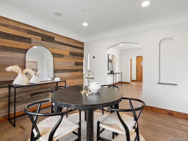 2535 Leyden St, Denver, CO 80207 - dining room featuring wooden walls, arched walkways, baseboards, wood finished floors, and recessed lighting