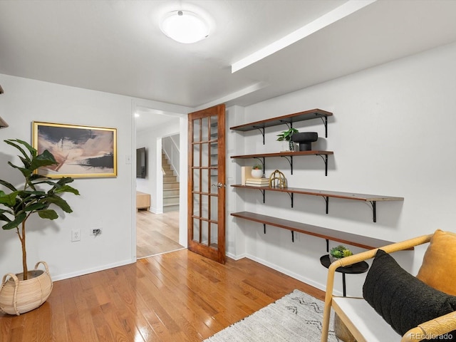 2535 Leyden St, Denver, CO 80207 - living area featuring light wood-style flooring, baseboards, and stairs