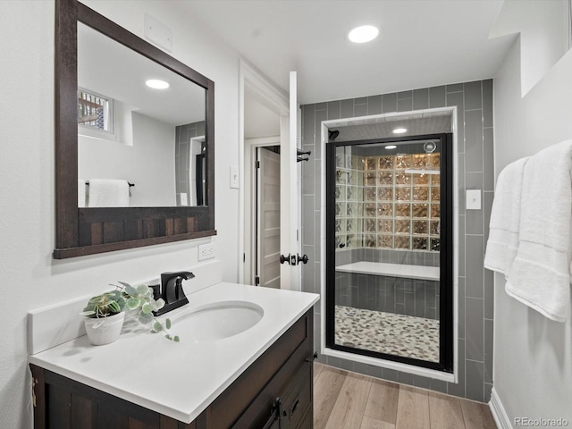 2535 Leyden St, Denver, CO 80207 - full bathroom with a shower stall, wood finished floors, vanity, and recessed lighting