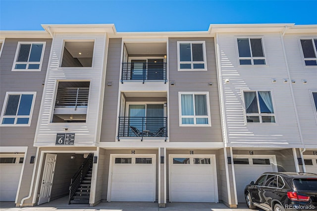 view of property featuring a garage and a balcony