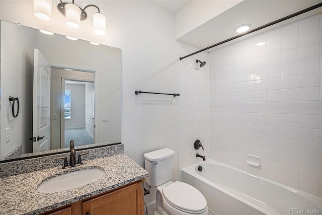 bathroom featuring toilet, washtub / shower combination, and vanity