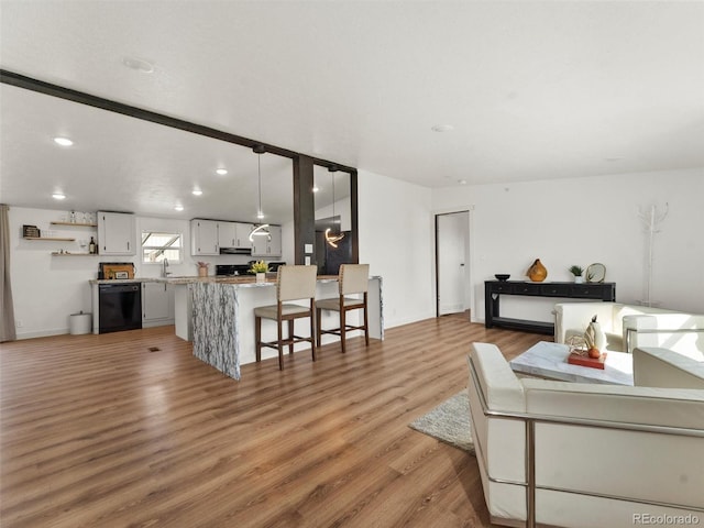 69501 E 72nd Ave, Byers, CO 80103 - living area featuring light wood-style flooring and recessed lighting