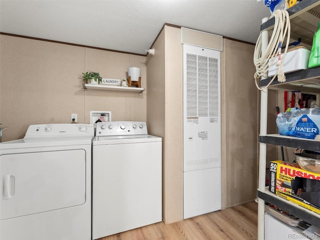 69501 E 72nd Ave, Byers, CO 80103 - laundry room with washer and clothes dryer and light wood-style floors