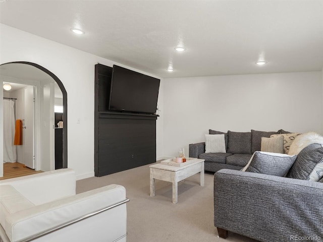 69501 E 72nd Ave, Byers, CO 80103 - living room featuring arched walkways, light colored carpet, and recessed lighting